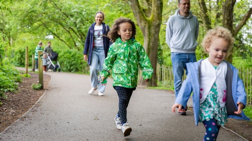 A family walking towards the Garden at Quarry Bank